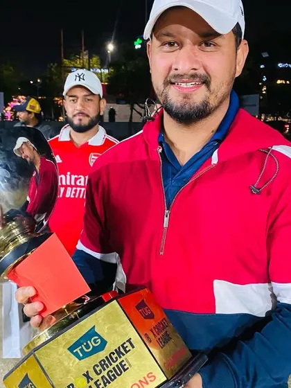 The captain of the Ground Shot Experts proudly holds the championship trophy after a successful TUG X Cricket League campaign.