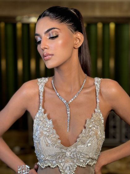 A close-up of the model, her hair pulled back tightly to emphasize her striking features.