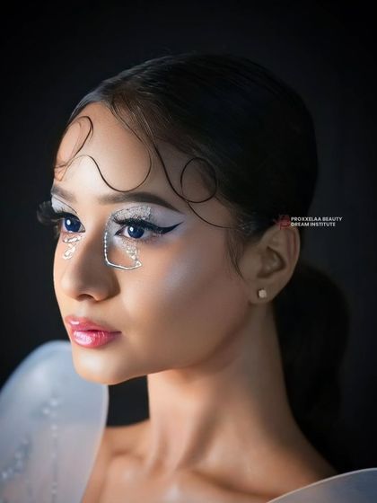 Stepping into a world of fantasy with this spellbinding look. The rhinestone details under the eye and the glossy lip create a look that is both delicate and magical.