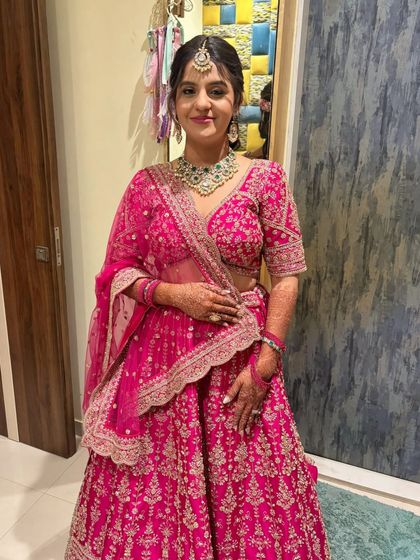 The complete wedding look. The bride looks stunning in her pink lehenga, with makeup that is both modern and pretty.