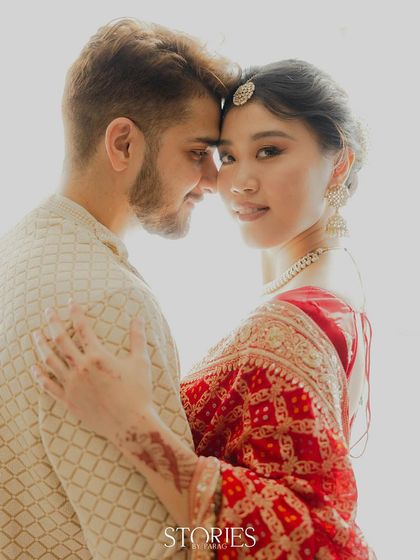 A bright, high-key portrait that beautifully highlights Carrie's features and the intricate details of her maang tikka. This shot with Nick showcases a soft, romantic, and ethereal mood.