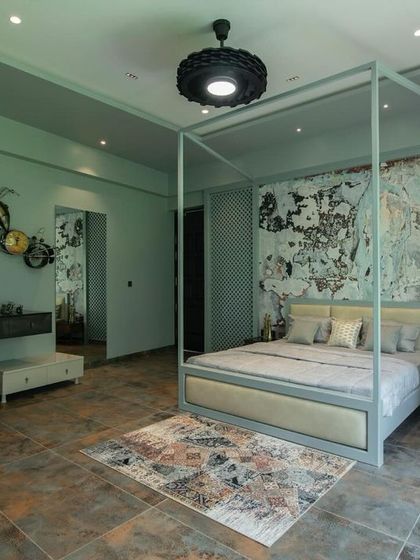 A wider view of the artistic bedroom, showing the white wardrobe and a unique bicycle-themed wall sculpture. The design balances eclectic decor with a clean, organized layout.