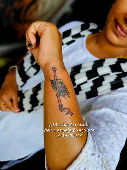 Another variation of the peacock feather and flute design, this one in black and grey.