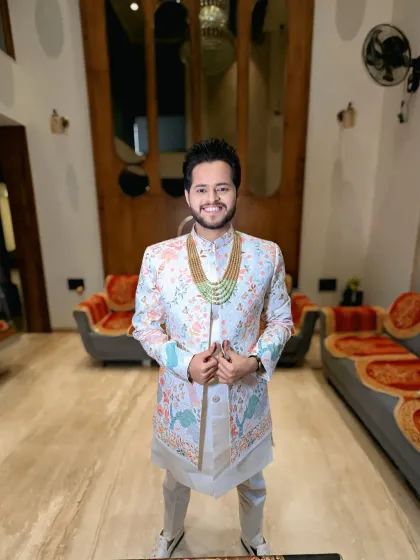The complete look, showing off the intricate and colorful embroidery of the sherwani. The groom looks ready for a grand celebration.