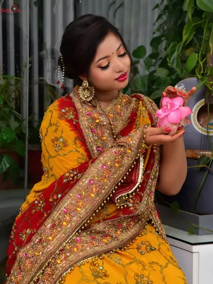 A gentle and artistic portrait with the model holding a pink flower. The use of props and soft focus adds a creative touch to the portfolio session.