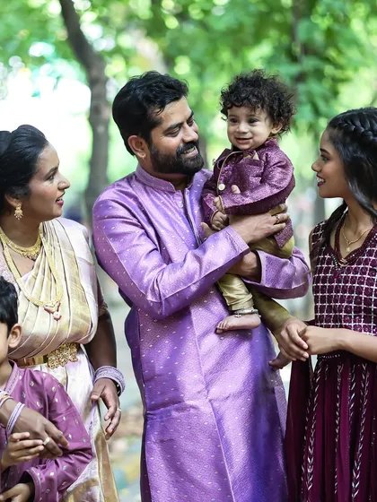 A candid family portrait taken outdoors. I love capturing the natural interactions between parents and their children in a relaxed setting.