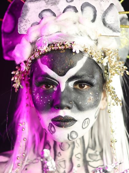 A celestial moon goddess look, using black and white body paint to create a striking contrast.