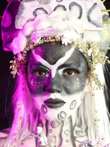 A portrait of the celestial character, revealing the elaborate headdress and the piercing gaze enhanced by the makeup.