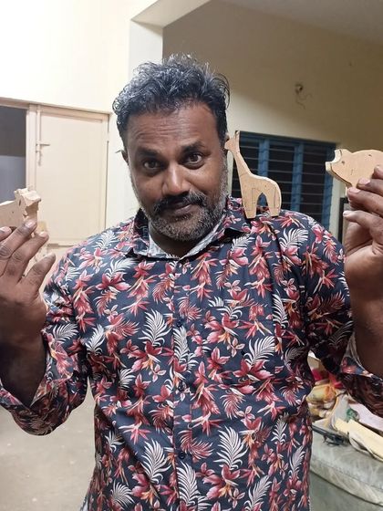 Ajesh showing off his growing collection of wooden animal cutouts. These are perfect for nursery decor or as part of a larger art piece.