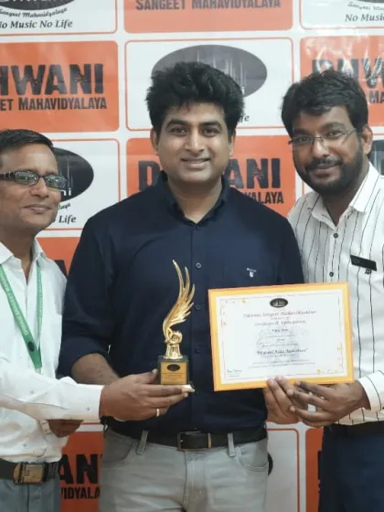 An adult student receives his award from our faculty for his excellent work.