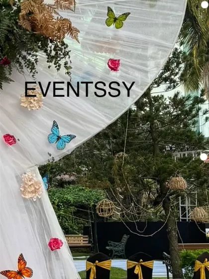 A detail of the sheer drapery and butterfly accents used in the 25th birthday decor, adding a touch of whimsy to the elegant floral theme.