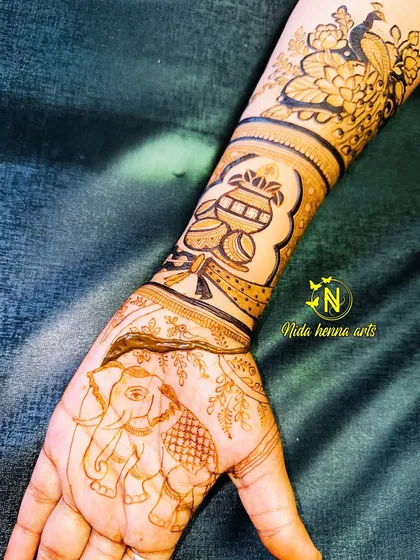 A full hand design in progress, showing how the kalash on the wrist connects to an elephant design on the palm.