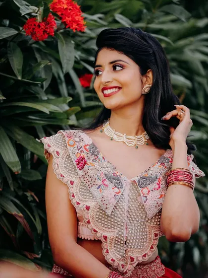 This vibrant red lehenga was for a Sangeet or Mehendi event. I created a fun and glamorous look with a bold red lip and soft, romantic hair.