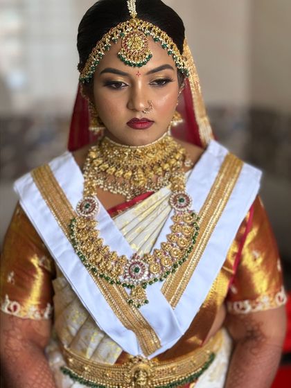 Another angle of this powerful bridal look, showing the detailed eye makeup and the traditional nose ring. The entire look is balanced to feel grand yet elegant.