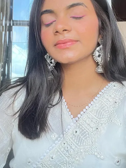 A close-up showing the sharp pink wing. Paired with glossy lips and glowing skin, it creates a fresh and modern vibe.