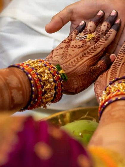 A duplicate of the previous image. This view shows both palms during the ceremony, highlighting the symmetry and richness of the henna design.
