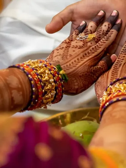 A duplicate of the previous image. This view shows both palms during the ceremony, highlighting the symmetry and richness of the henna design.