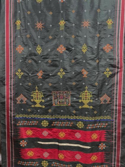 An exquisite example of advanced Kasuti work on a dark silk fabric. The intricate patterns, including temple gopuras and floral designs, are meticulously stitched to create a rich tapestry of tradition.