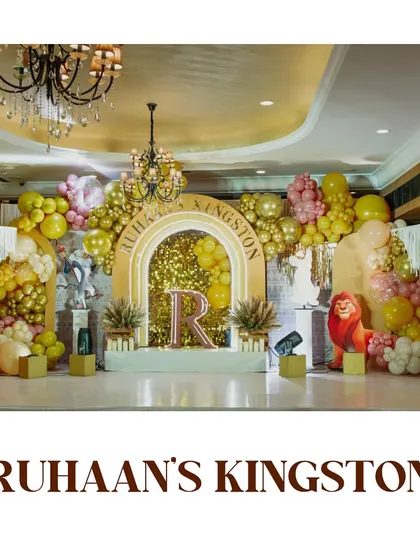 A wide shot of the "Ruhaan's Kingston" stage setup. The combination of balloons, props, and lighting transformed the venue into a true jungle kingdom.