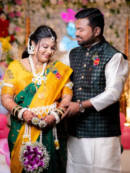 A beautiful couple at their baby shower. She is wearing a full set of my white and yellow floral jewellery, including a kamarband and bajuband.