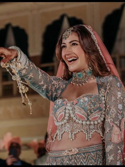 A candid, happy moment captured in our designer pastel green lehenga. This is the kind of unforgettable look we love to provide for our clients' big days.