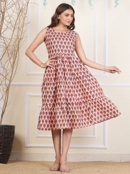 This tiered dress features a geometric leaf-like block print in a lovely shade of maroon.