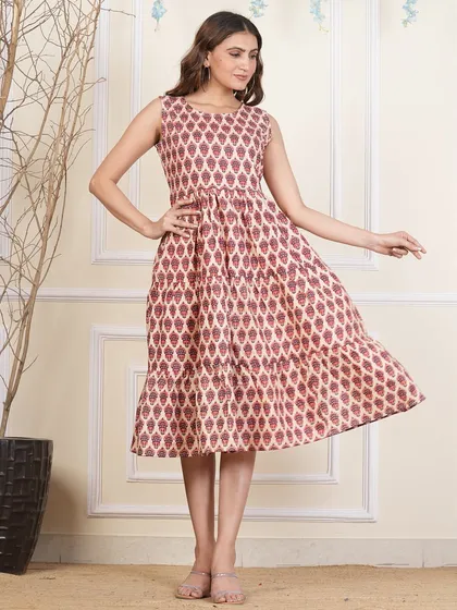 This tiered dress features a geometric leaf-like block print in a lovely shade of maroon.