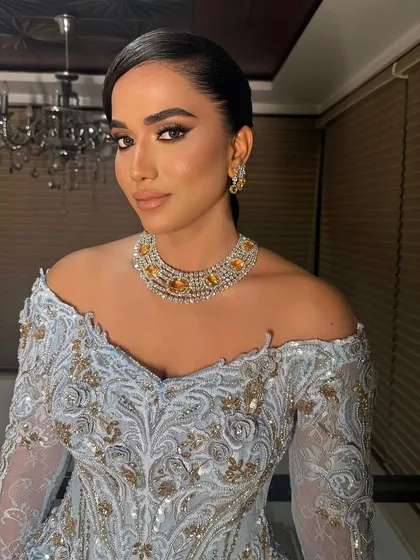 A classic and clean hairstyle that exudes grace. The side-parted bun is a versatile choice that works beautifully for brides, bridesmaids, or family members.