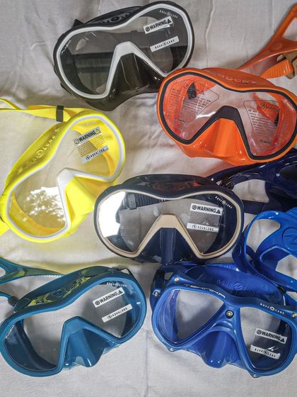 A vibrant collection of new dive masks from Aqualung and Apeks. This assortment shows the variety of styles and colors available, ensuring every diver can find a mask that fits their face and their personality.