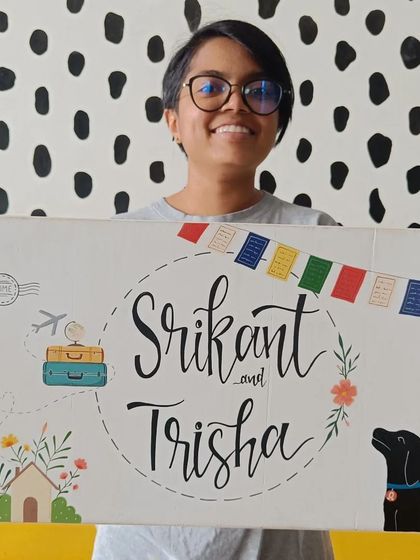 One of our team members proudly holding the finished "Srikant and Trisha" name board, a piece filled with personal stories and happy vibes.