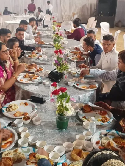Guests seated and enjoying their meal at a wedding featuring my royal setup. I can arrange for elegant table settings that match the grandeur of the buffet.
