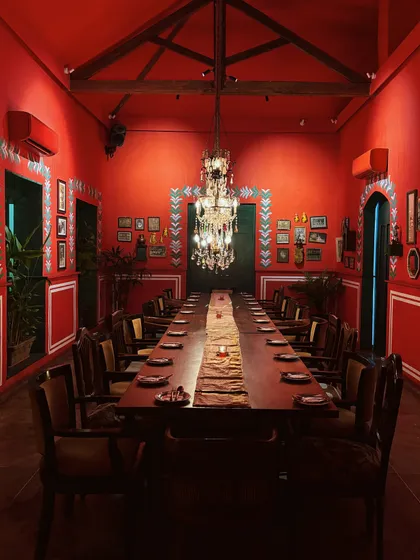 The definition of susegad. This stunning, all-red dining room in Goa is a masterclass in bold interior design and creating a mood.