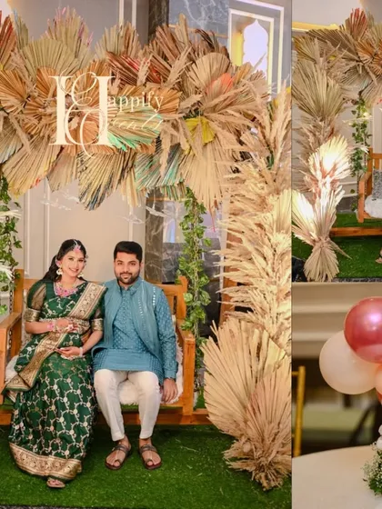 A cozy and rustic swing (jhoola) setup for a baby shower. The wooden swing is decorated with dried palm leaves and greenery, creating a beautiful and comfortable photo spot for the expecting couple.