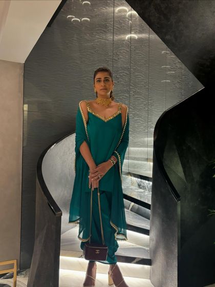A chic and modern Indian look. This emerald green cold-shoulder kurta set is perfect for a Diwali party or a wedding cocktail event.