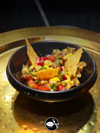 This is my Khasta Nacho Chaat, a fusion dish that combines the crunch of Mexican nachos with the tangy spices of Indian chaat. It's a unique and crowd pleasing appetizer that guests always love.