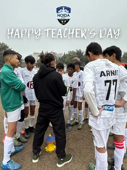 A coach huddles with his team, teaching the importance of teamwork, resilience, and passion. Our coaches are mentors on and off the pitch.