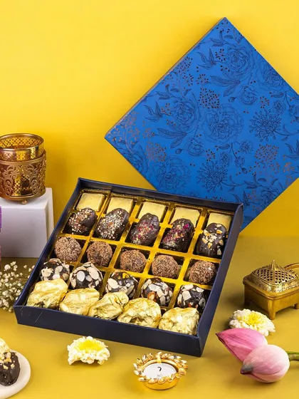 I used a bold yellow and blue color scheme for this shot to highlight the intricate design of the chocolate box. The composition draws the eye directly to the delicious assortment of sweets inside.