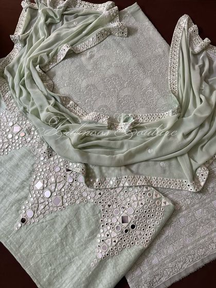 This image highlights the combination of the heavily embroidered kurta and the mirror-adorned palazzo, creating a balanced and luxurious ensemble.