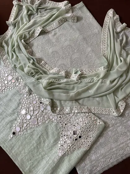 This image highlights the combination of the heavily embroidered kurta and the mirror-adorned palazzo, creating a balanced and luxurious ensemble.