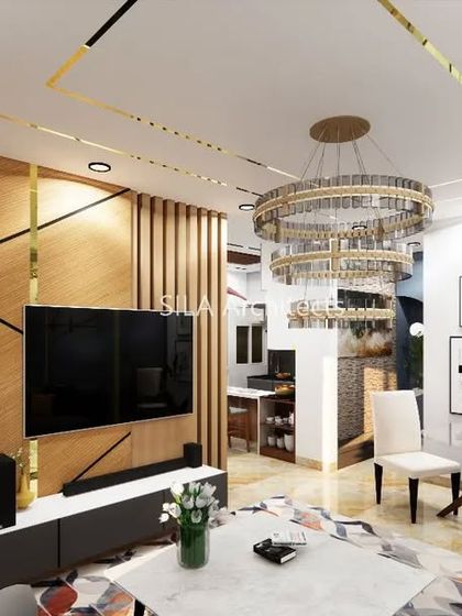 A luxurious living room design for a project in Bannerghatta, featuring gold accents, a grand chandelier, and a mix of wood and fabric textures.