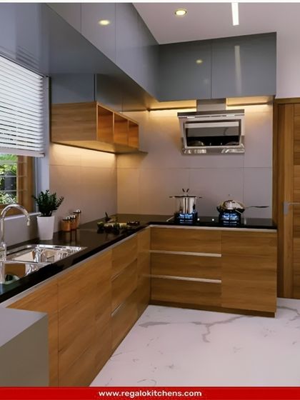 This L-shaped kitchen combines natural wood cabinets with a sleek black countertop and grey upper cabinets. The layout is perfect for a corner space, maximizing functionality without feeling cramped.