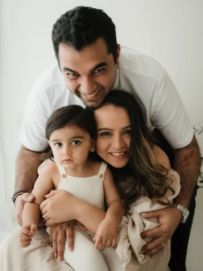 A fun and cuddly family portrait. The genuine smiles and close embrace show the love and connection this family shares.