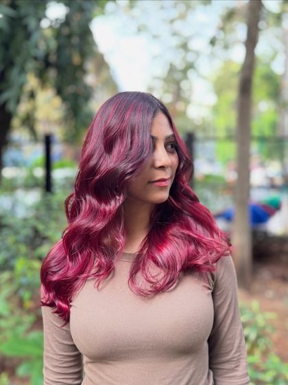 Got red hair and wings. This vibrant, fiery red is for the bold and fearless, styled in beautiful waves to show off its intensity.