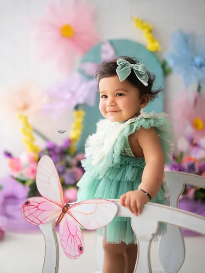 A beautiful profile shot of this sweet baby girl on the magic bridge, with a butterfly perched nearby.