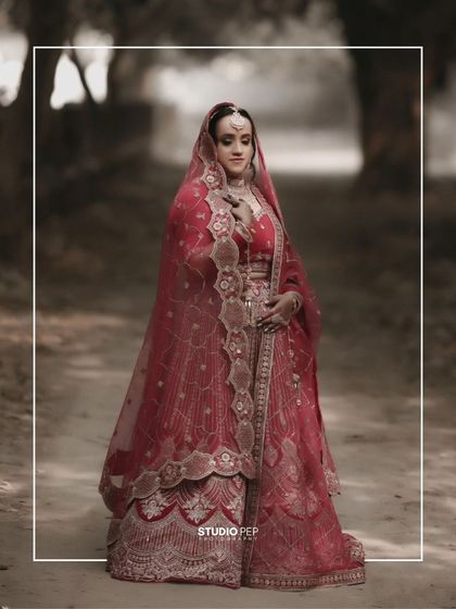 A full-length, moody portrait of Shreya in a rustic, wooded area, the contrast creating a dramatic and unique bridal photo.
