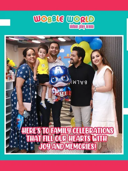 A family poses with a Captain America balloon at their little one's party. It's these small, themed details that make the day extra special.