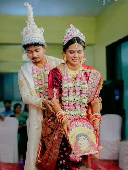 The couple standing together during a wedding ritual, a beautiful portrait of their union.