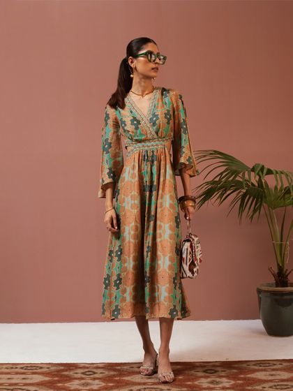 Styling a printed cut-out dress from Ritu Kumar's SS24 collection. This look is a perfect example of modern resort wear, blending a classic print with a contemporary silhouette.