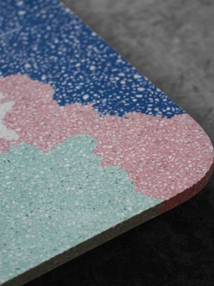 Another detail of our multicolor terrazzo, showing the transition between pink, blue, and mint green sections. Each color is carefully poured to create these organic shapes.