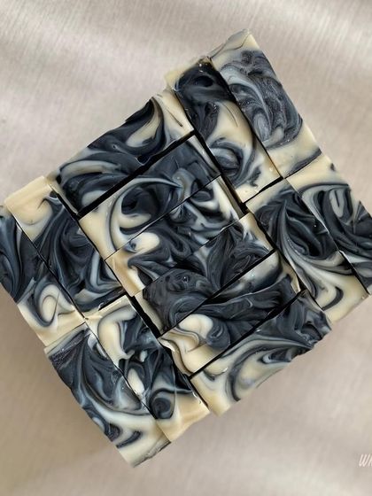 The beautiful, intricate swirls of our Charcoal Detox Bar. We use activated charcoal to draw out impurities, making it a perfect cleansing bar for the face and body.